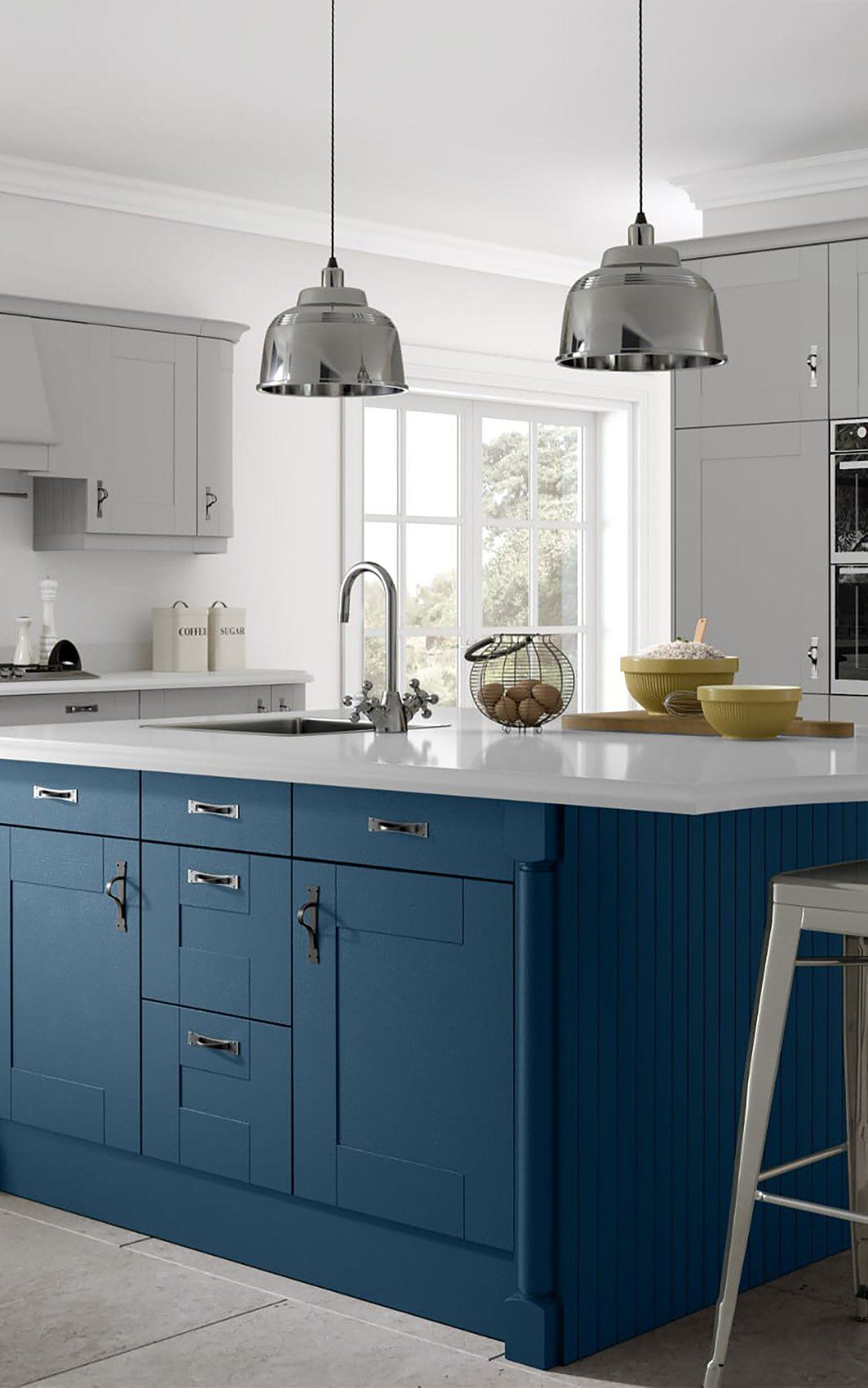 Stone worktop fitted in a painted blue bespoke kitchen