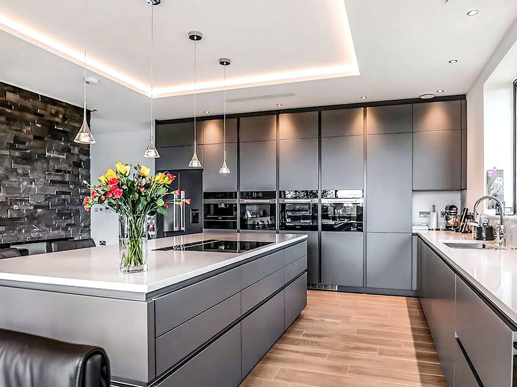 Handleless graphite grey kitchen with large island, quartz worktop and full-height appliance wall